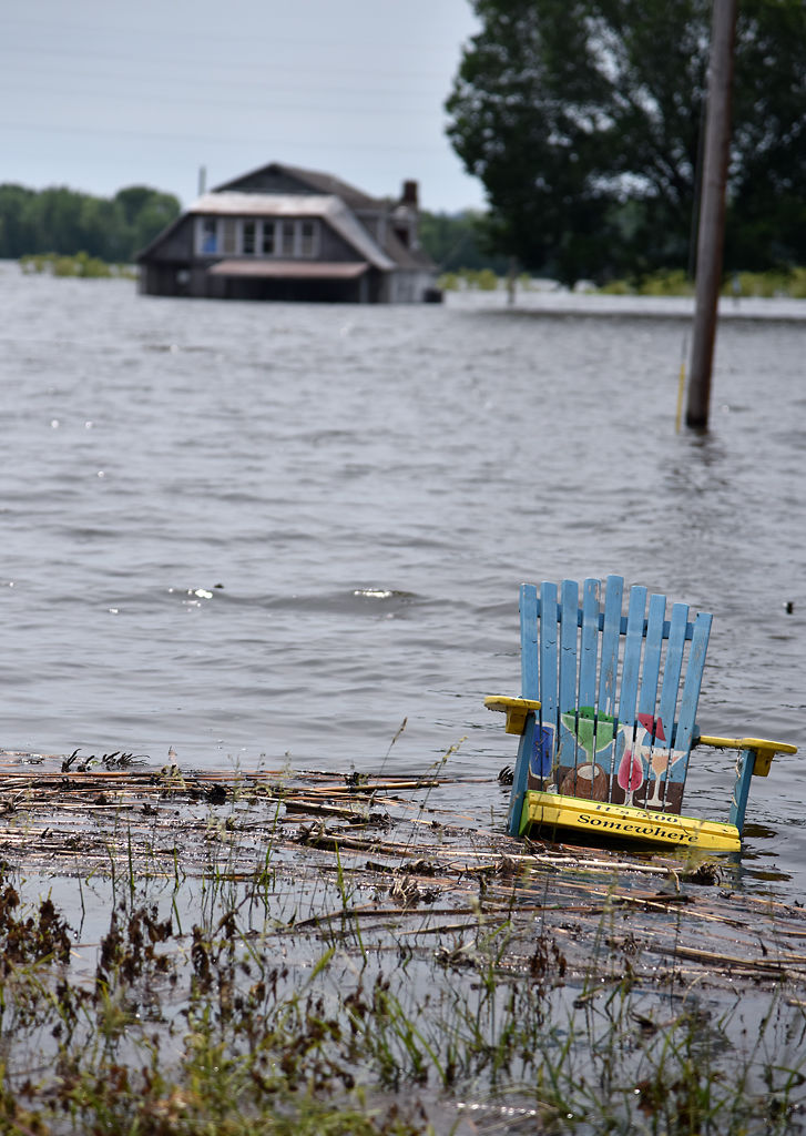 A lawn chair floats near the flooded Katy Trail